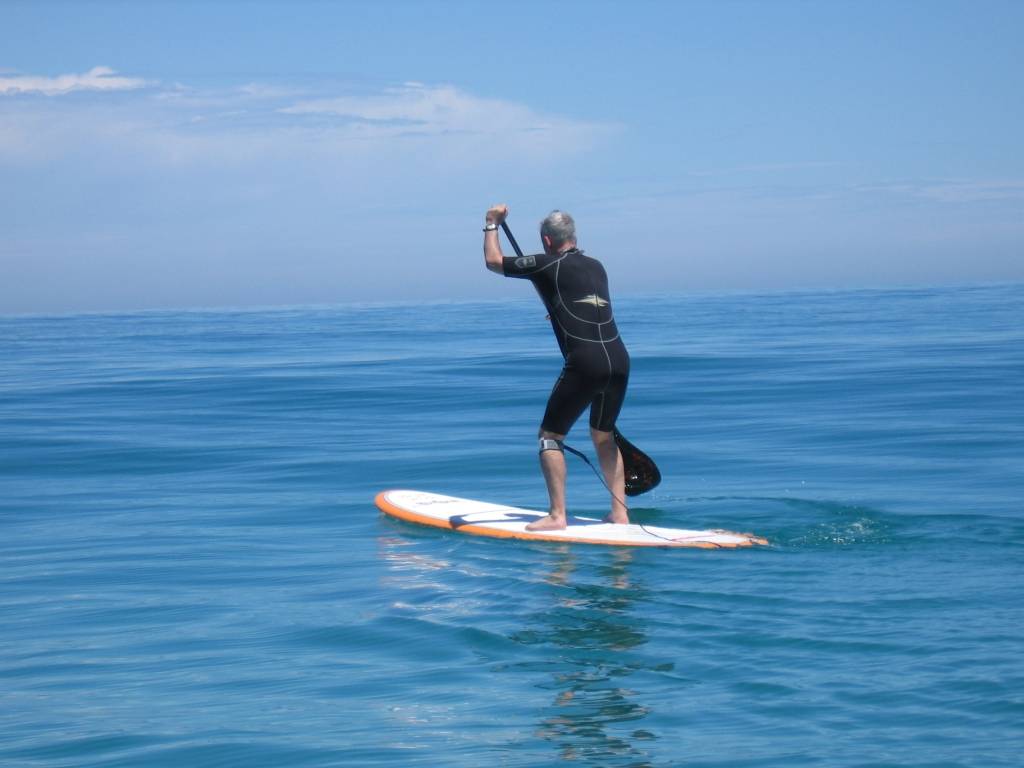 Dave paddles off to the lineup