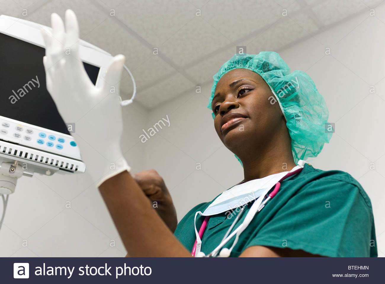 nurse-putting-on-latex-gloves-BTEHMN