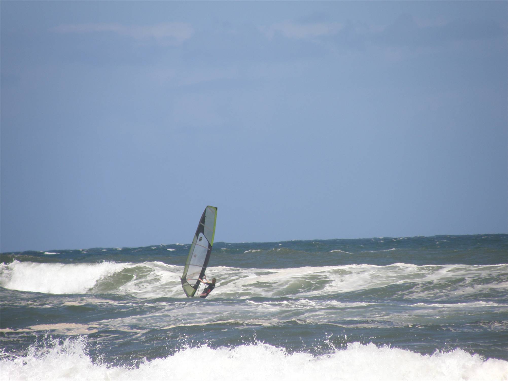 heading out in light onshore mush on a freestyle board